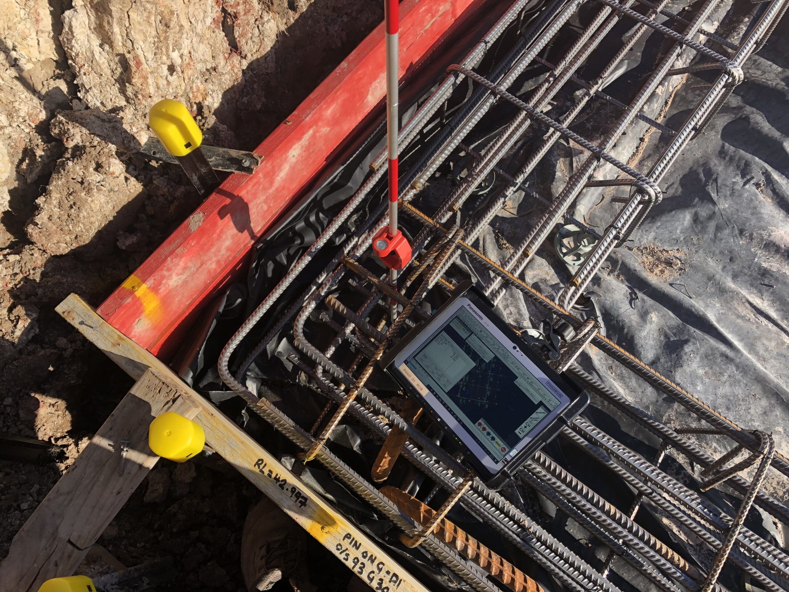 Photo 3-7-20, 9 18 38 am Survey tablet and GNSS pole resting on a reinforcing cage during as-built capture