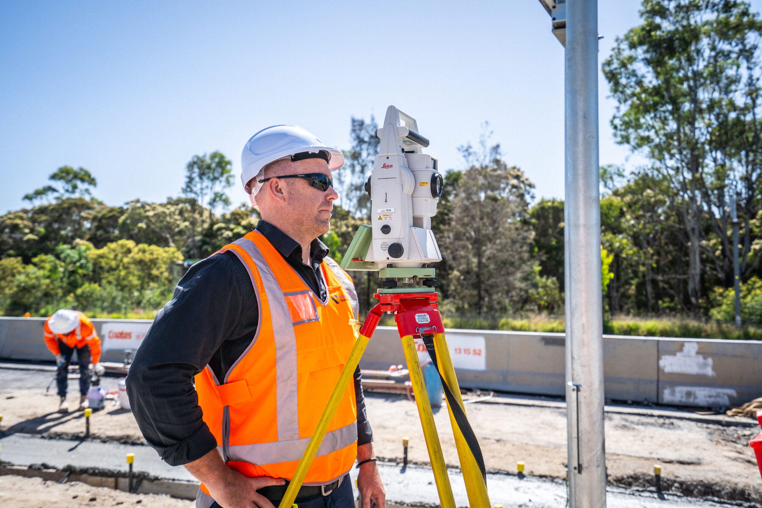 RCS-M7–118 Surveyor in hi-vis operating a total station on a bridge deck